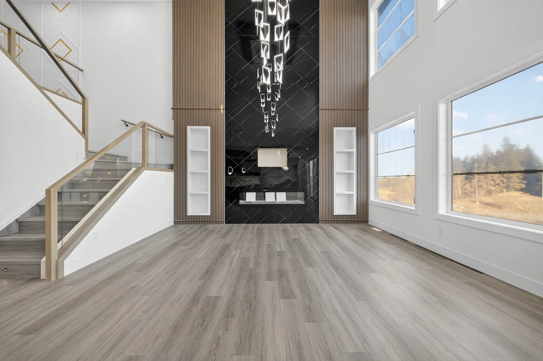 Open-to-above living room with a full-height fireplace feature wall in the Cavanagh residence