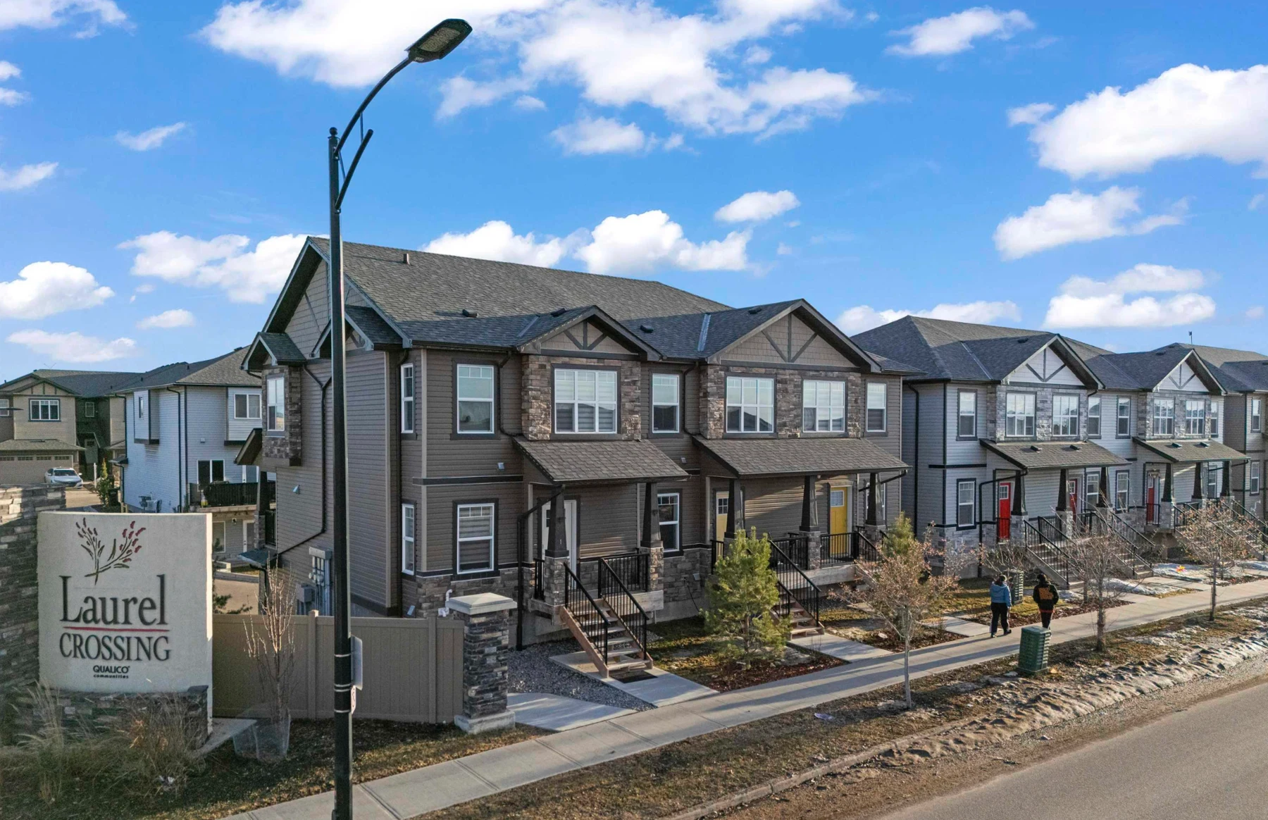 Street-facing homes at The Palms at Laurel with front porches and stone accents