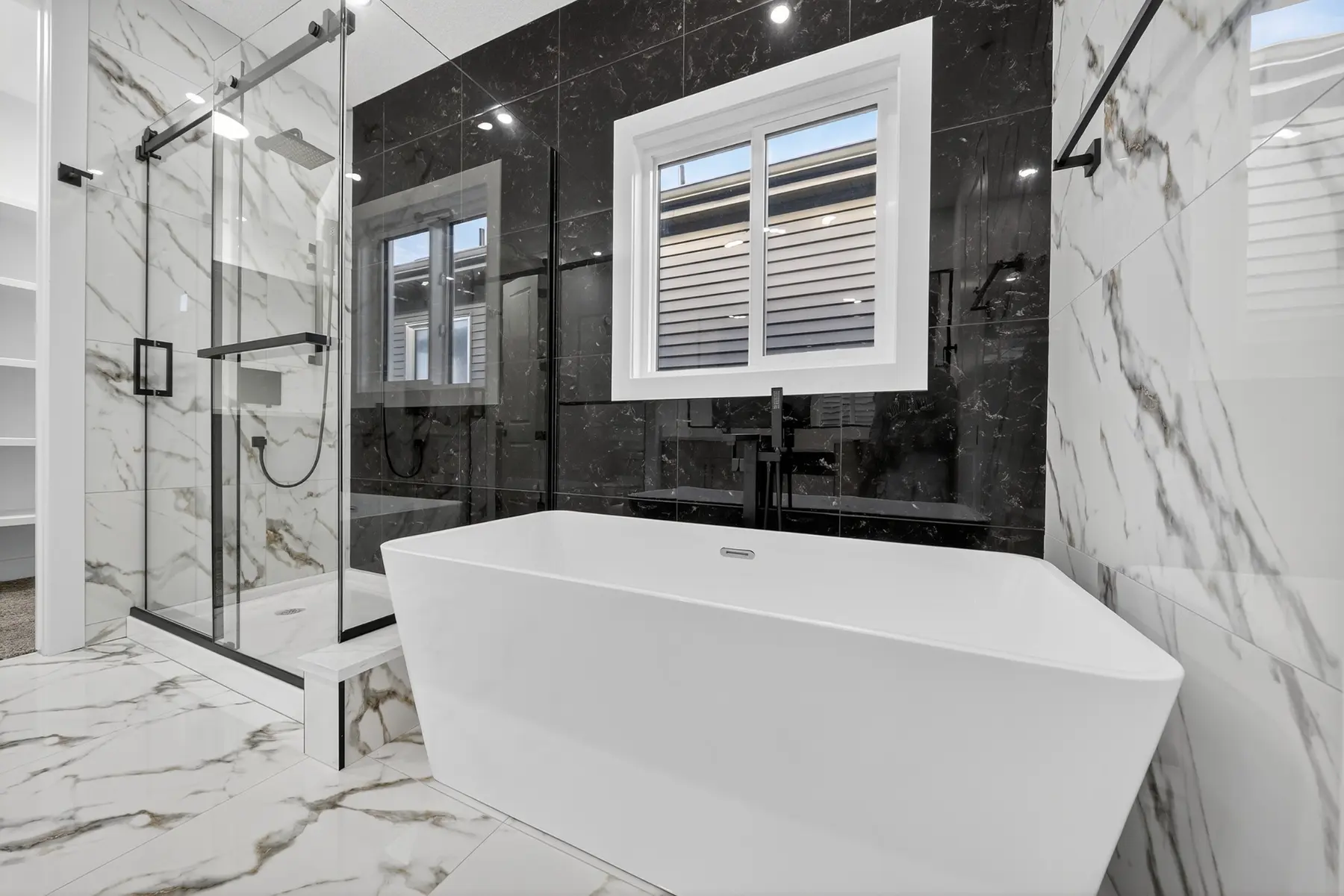 Primary ensuite with freestanding tub and tiled shower in the Cavanagh residence