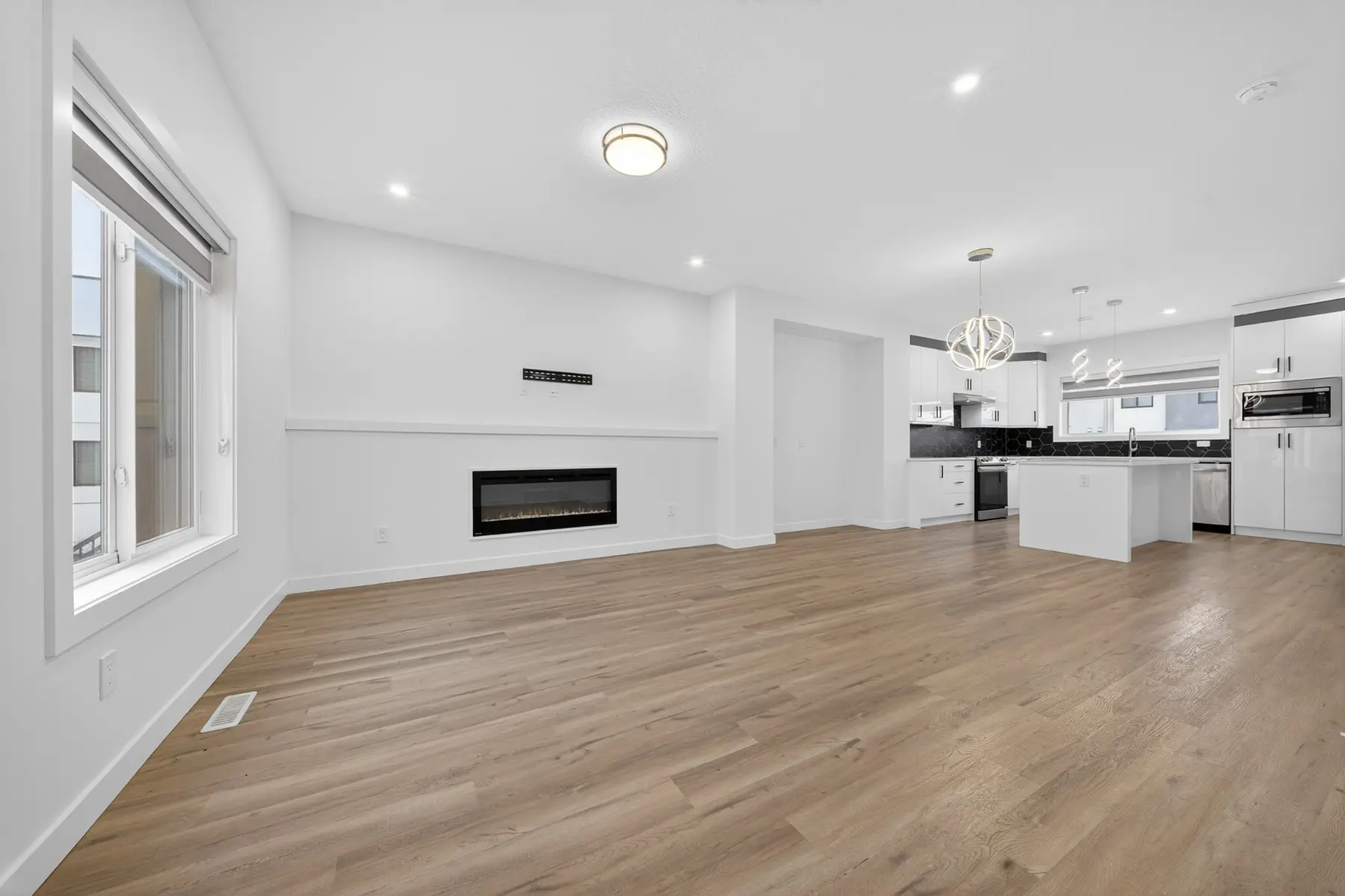Open-concept living room and kitchen inside a home at The Palms at Salisbury
